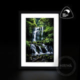 Tiered Falls waterfall artwork with cascading water, moss-covered rocks and lush green forest by Hiriwā Digital Art.